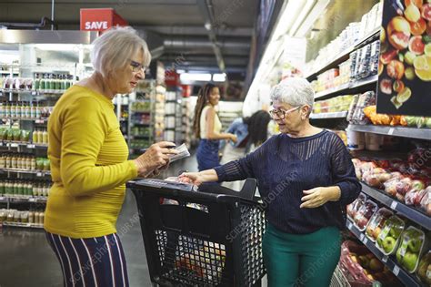 senior women grocery shopping in supermarket stock image f030 2087