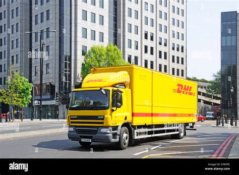 yellow dhl deutsche post delivery lorry truck driving  london street  tower hamlets