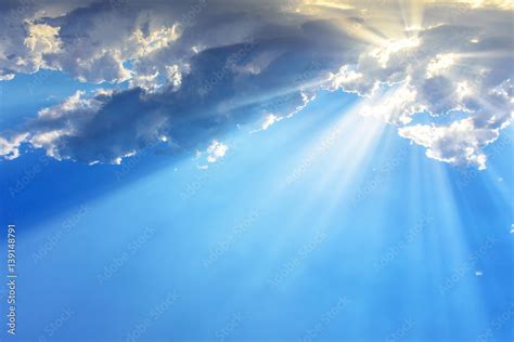 sun light rays  beams bursting   clouds   blue sky