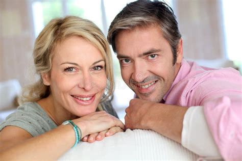 mature couple lying on sofa stock image image of close married 65074217