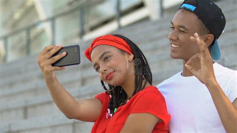 Smiling Afro American Teen Couple Fooling Around And Making Selfie