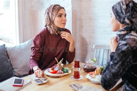 Two Muslim Women In Cafe Shop Online Using Electronic