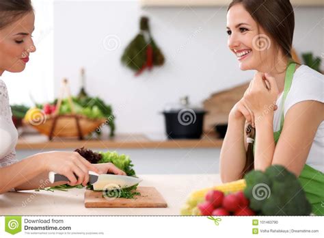 Two Women Is Cooking In A Kitchen Friends Having A