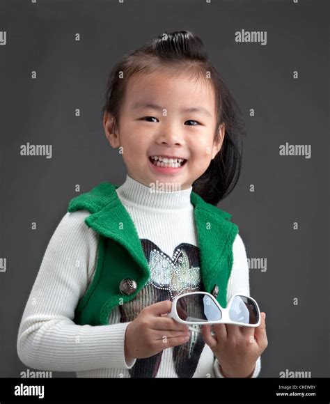 very bright responsive happy 4 year old chinese girl in smart outfit