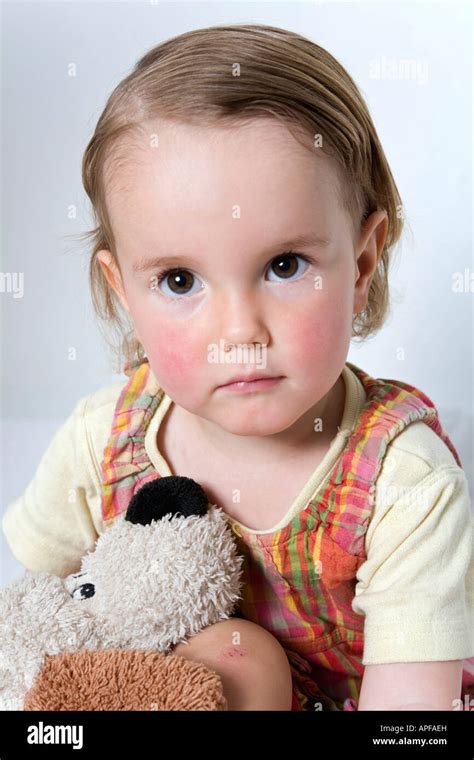 young child holding  stuffed animal stock photo alamy