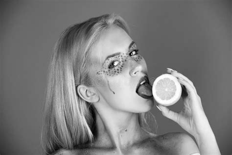 Pretty Blonde Woman With Creative Fashionable Makeup Lick Lemon