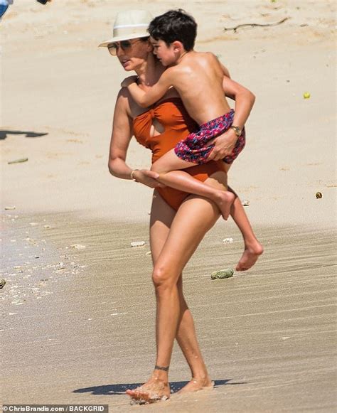 lauren silverman looks incredible in a bronze swimsuit with cutout detail as she hits the beach