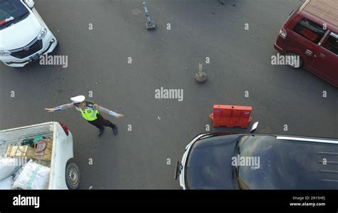aerial photo of the traffic police directing the direction of vehicles