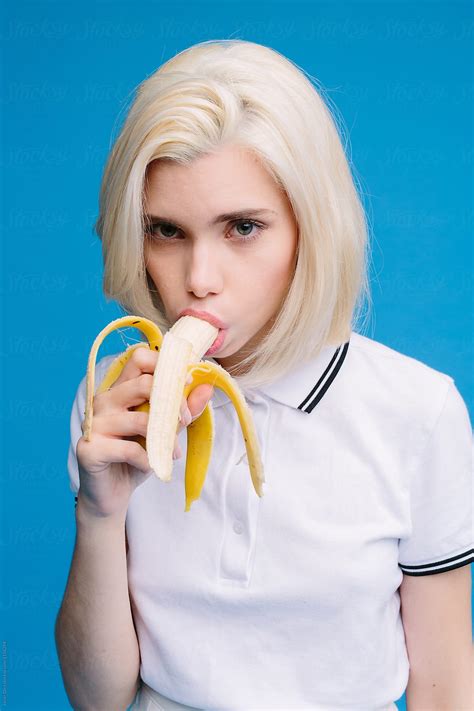 attractive blonde girl eating banana seductively by javier