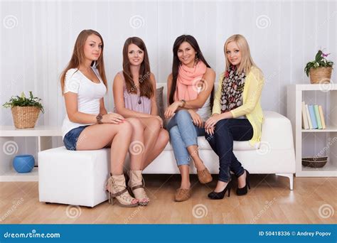 Young Ladies Tourists Sitting Together On Stair At Fontanka River