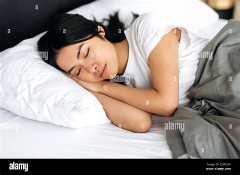 Side View Of A Sleeping Asian Girl In A Cozy Bed In Apartment Pleasant