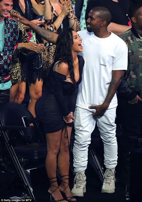 kim kardashian and kanye west seem engrossed in their phones backstage