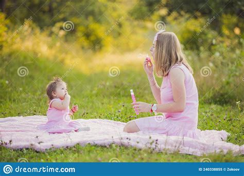 mother and daughter blowing bubbles stock image image of blow woman