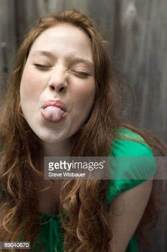 girl late teens or early 20s sticking out tongue photo getty images