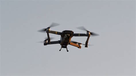 darpa video shows autonomous drones swarming  building slashgear