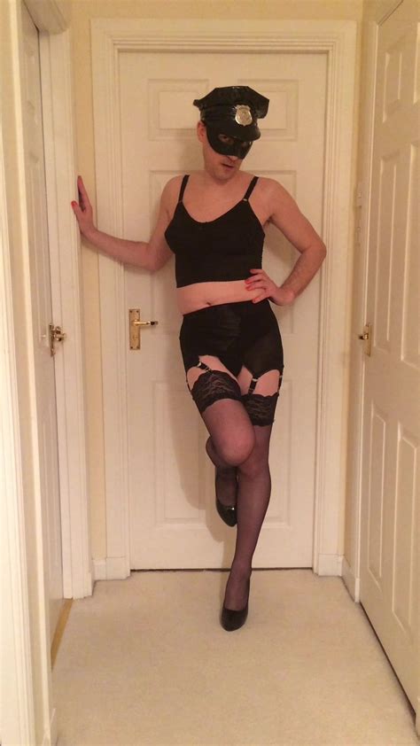 crossdressing posing in gay cop lingerie stockings and