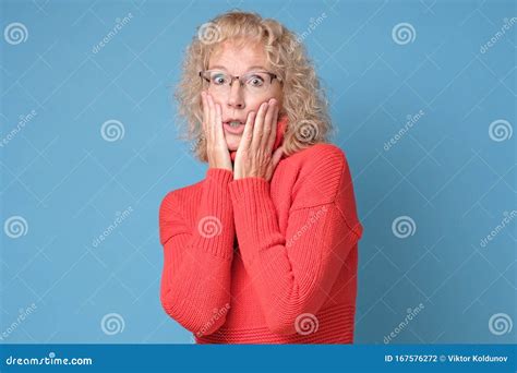 frustrated senior woman looking at camera with worried puzzled