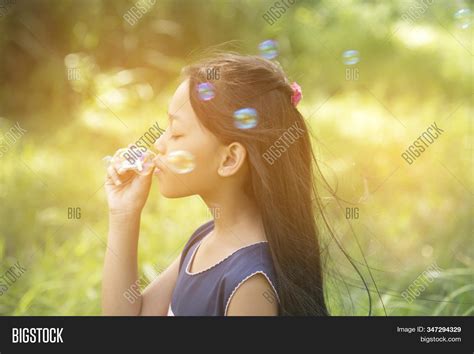 Cute Girl Play Blowing Image And Photo Free Trial Bigstock
