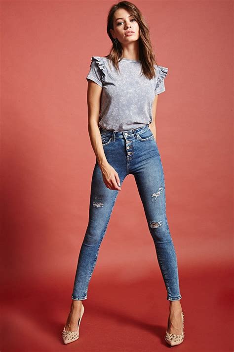 a pair of denim woven skinny jeans with a high waisted fit exposed