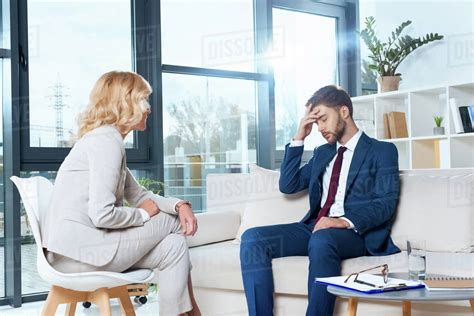 psychologist talking  depressed young patient  psychotherapy stock photo dissolve