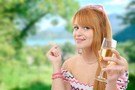 Pretty Redhead Woman Drinks A Glass Of Wine Greenery On Backgr Stock