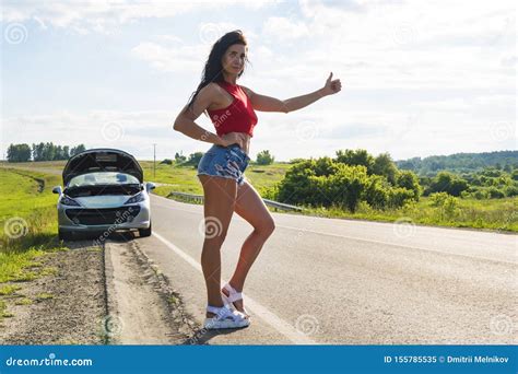 Beautiful Woman Hitchhiking By A Broken Car Girl Stands At His Car And