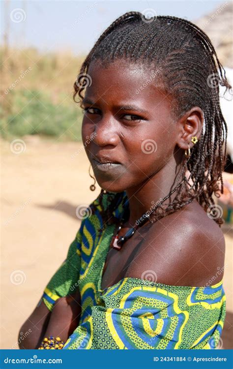 An African Girl Walking Long Distance To Fetch Water In Buckets