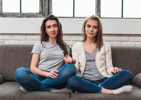 Free Photo Portrait Of Two Young Lesbian Couple Sitting On Sofa With