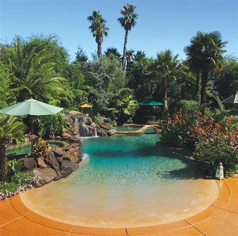 residential beach entry tropical pool  rock waterfalls  palm