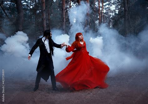 Blurred Silhouette In Motion Of Gothic Couple Dancing In Fog Vampire
