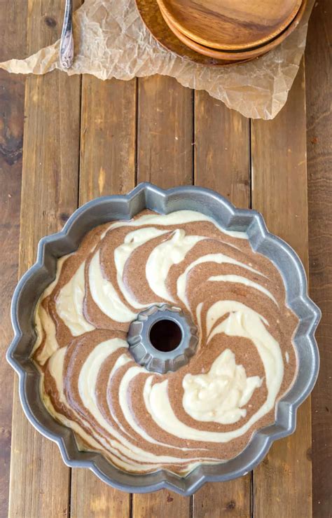 cinnamon swirl bundt cake batter   bundt pan   wooden background