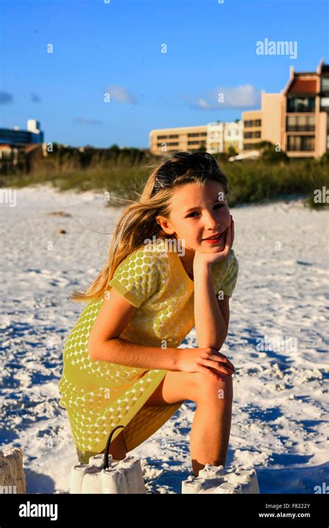 Young Girl Posing At Sunset By The Sand Castle She Built Free