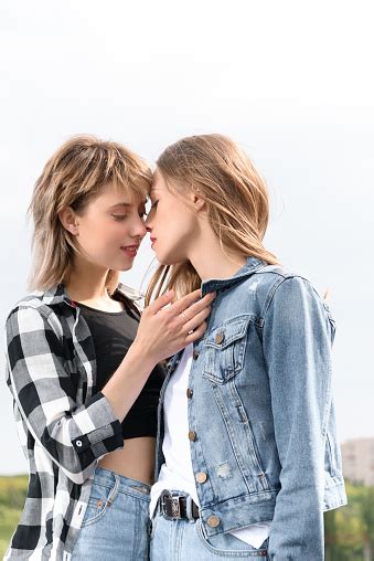 Young Lesbian Couple Kissing With Eyes Closed Outdoors