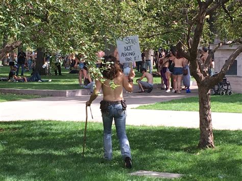 hundreds of topless people parade through central denver urging