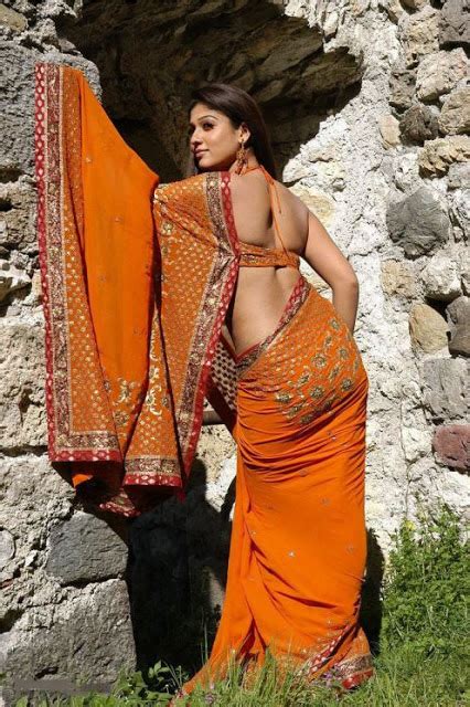 sexclusive stills nayanthara beautifully exposing her hot curves in orange saree