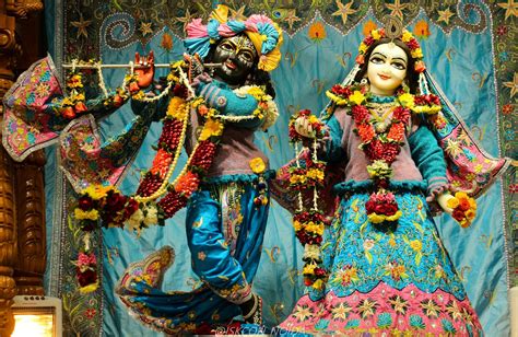 colorfully dressed statues  front   blue backdrop