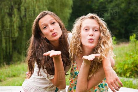 Two Teenage Girls Fooling Around In The Countryside And Blowing Kisses