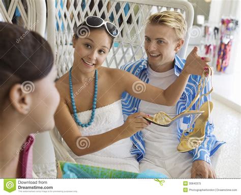 Girl Showing Off New Shoes To Friends In Clothing Store Stock Image