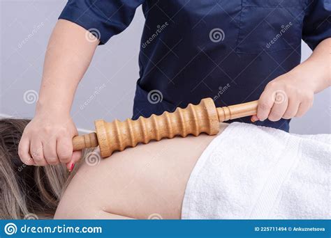 Female Hands Are Massaging The Patientand X27 S Back With A Roller