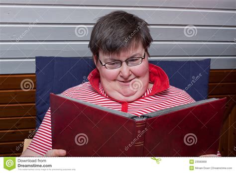 mentally disabled woman reads a book royalty free stock