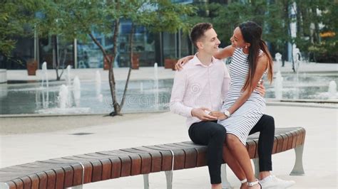 romantic multiracial couple having a date woman whispering something