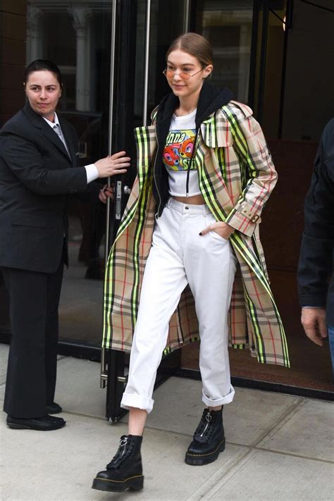 gigi hadid wearing dr martens lazy oaf jungle boots burberry laminated check trench coat