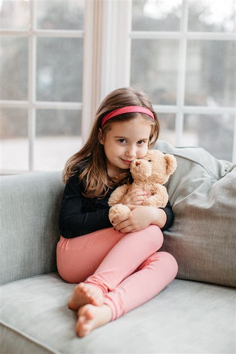 beautiful young girl sitting   big chair   teddy bear