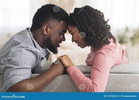 Romantic Black Couple Bonding At Home Holding Hands And Touching