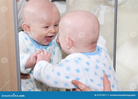 lachende baby die  spiegel kijken stock afbeelding image  terwijl baby