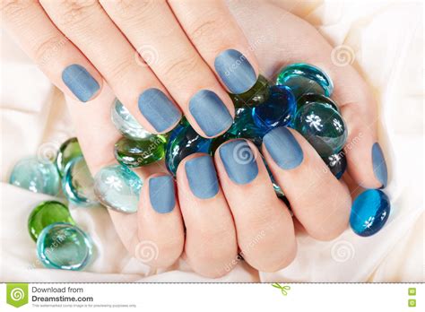 hand  blue matte manicured nails stock photo image  female