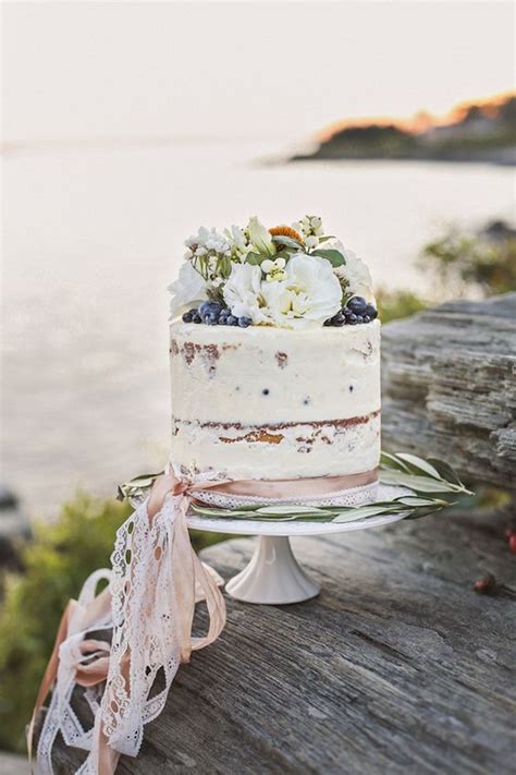 picture of single tier wedding cake with flowers and berries for a