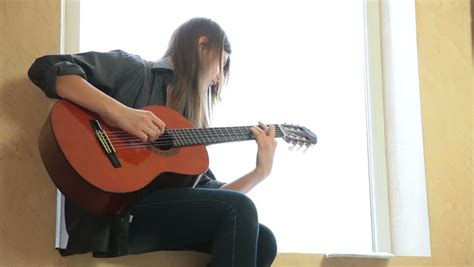 teen girl playing guitar at stock footage video 100 royalty free 9018346 shutterstock