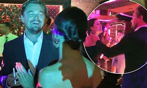leonardo dicaprio can t keep his eyes or hands off a mystery brunette