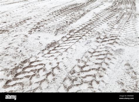 tractor tire tracks pattern  sandy white ground  winter abstract transportation background